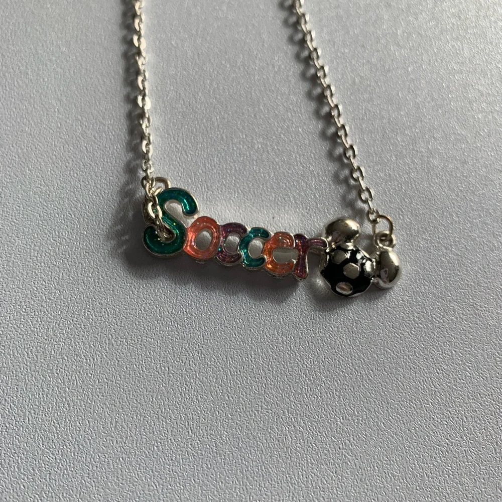 Disney girls soccer necklace.